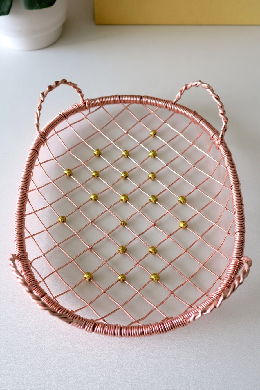Oval woven copper wire tray with decorative beads and twisted handles