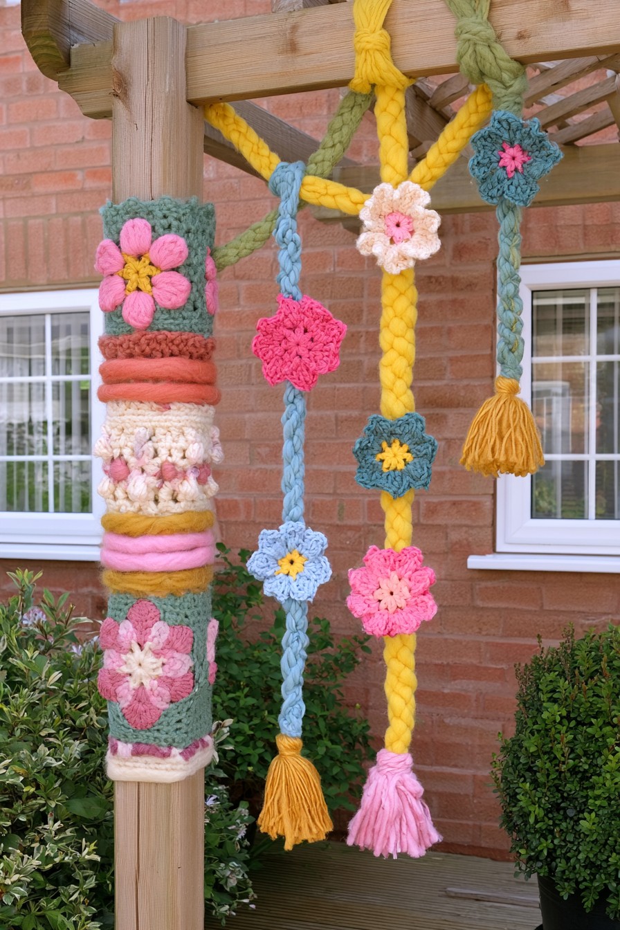 Garden pergola decorated with hanging crochet flowers