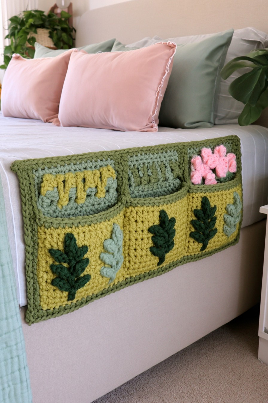 Green crochet bedside organizer with botanical pocket details