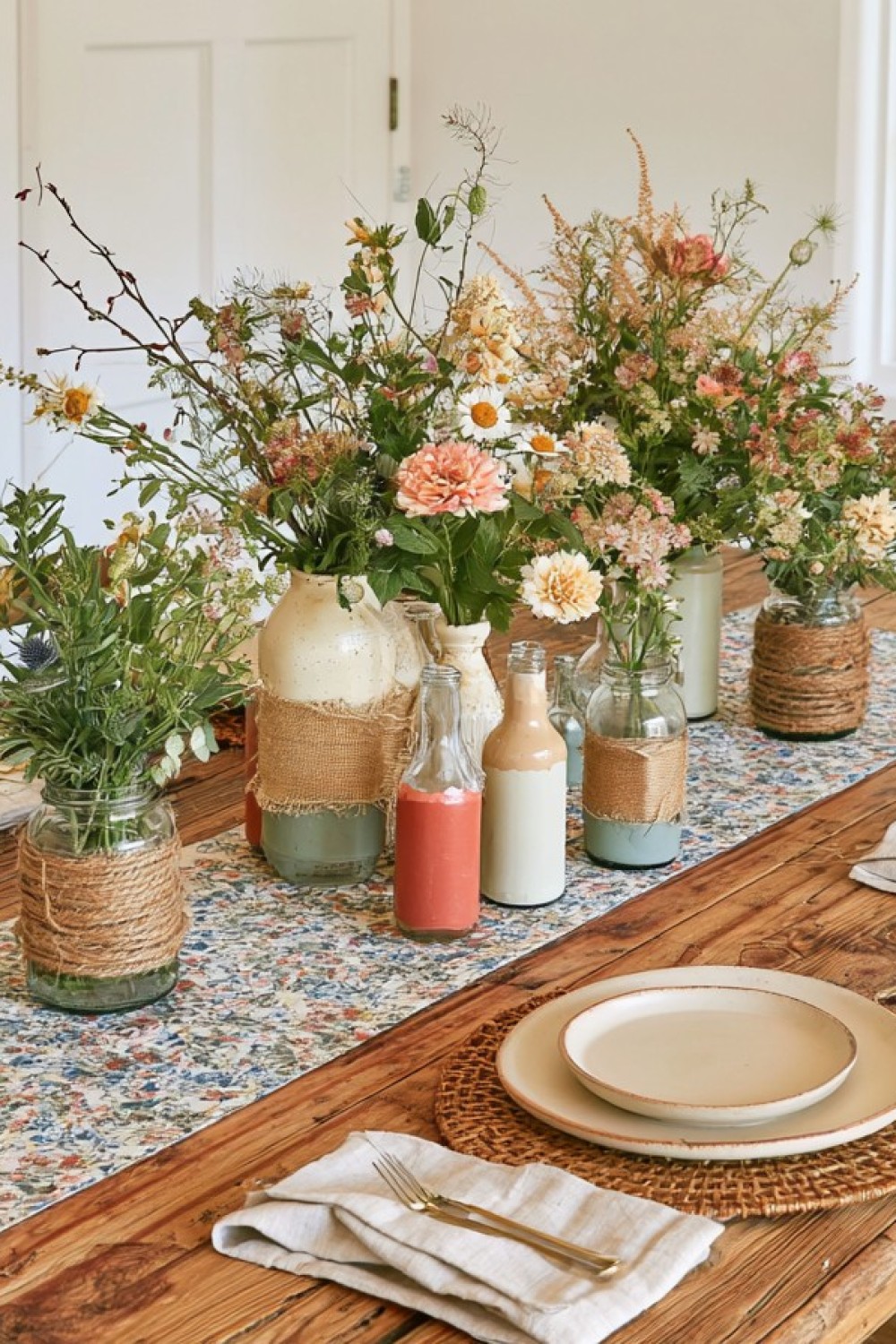 Clean repurposed glass jars arranged as small table vases
