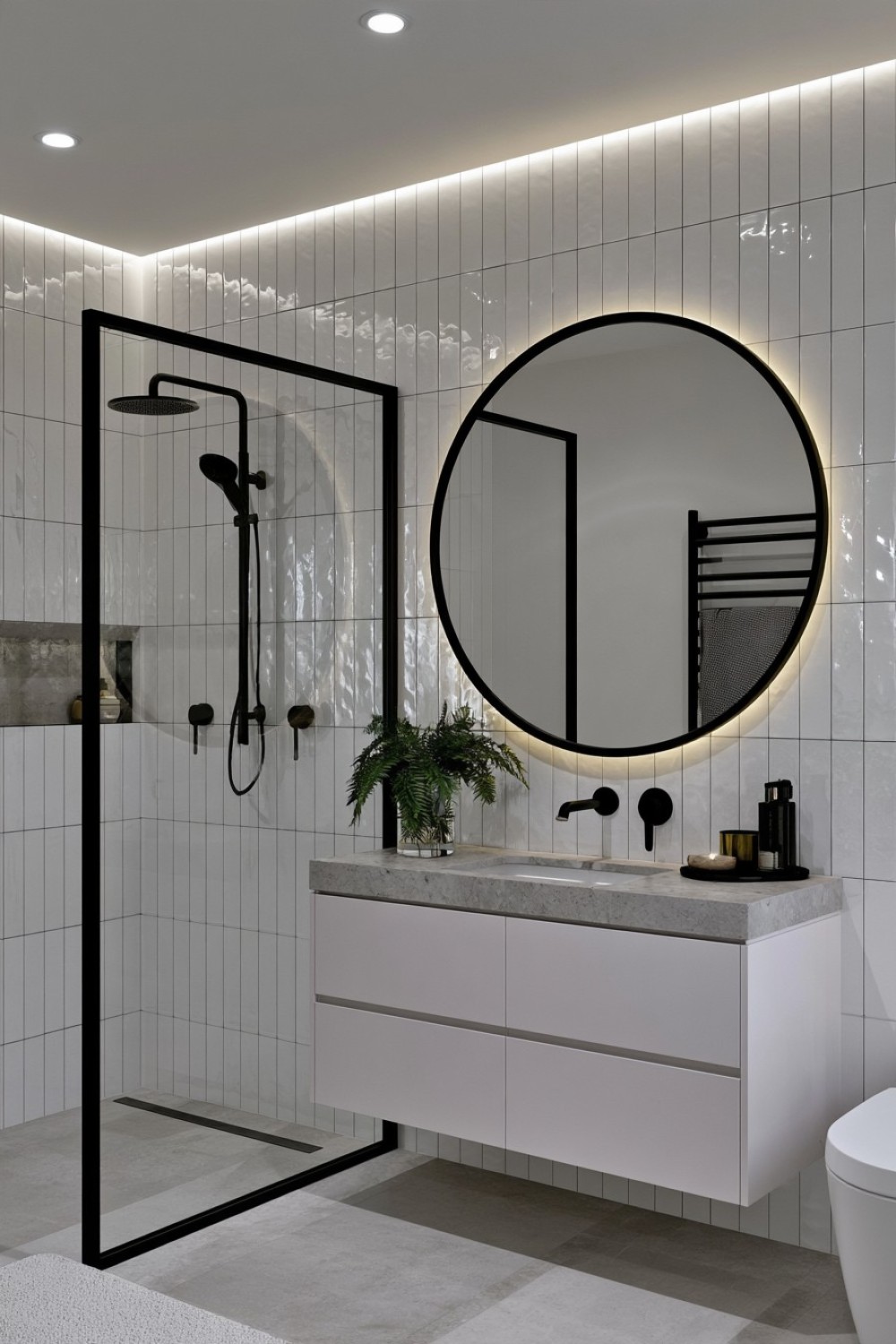 Glossy white bathroom tiles contrasted with matte black fixtures