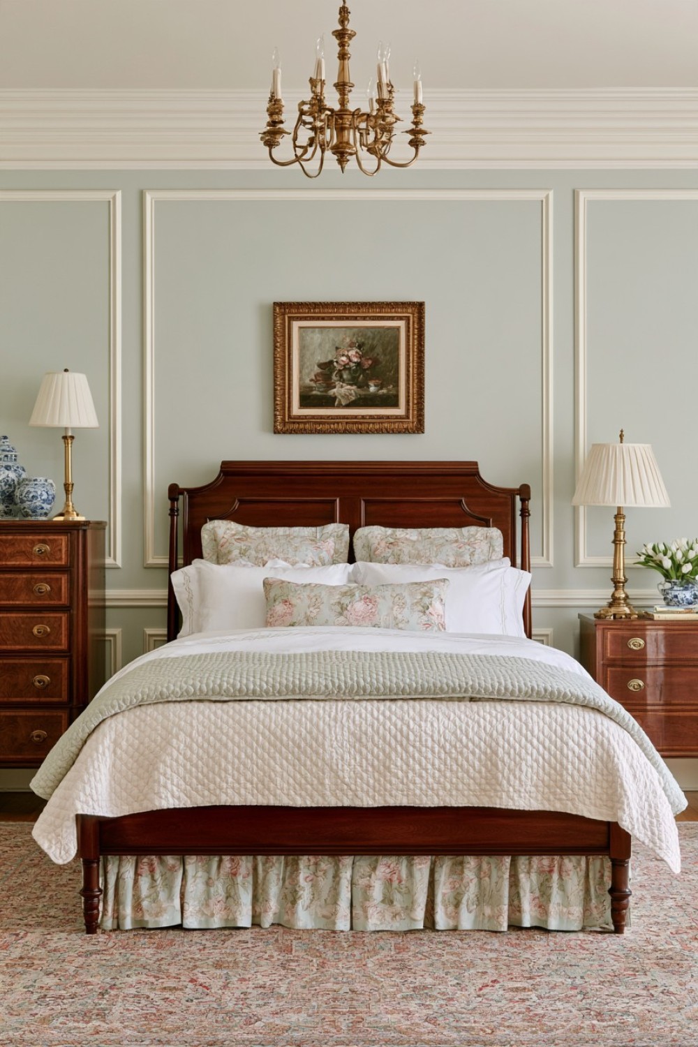 Dark wood bedroom furniture paired with pale celadon green walls