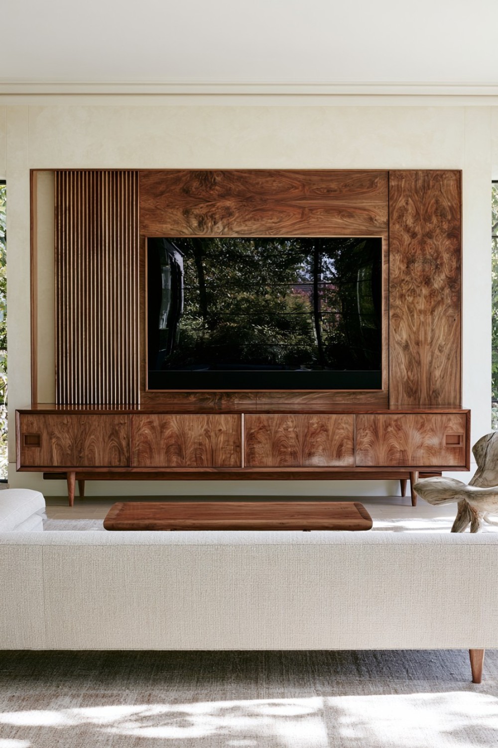 Mid-century modern living room with a sculptural walnut media wall