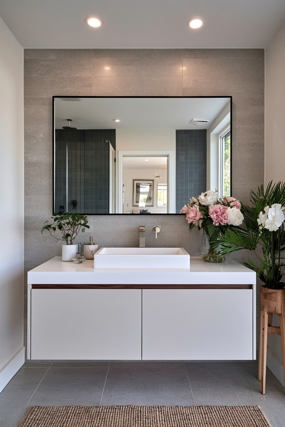 Full-width bathroom mirror installed above a compact vanity