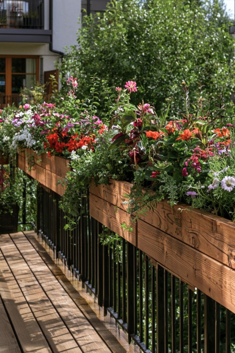 Narrow planter boxes attached securely to a patio railing