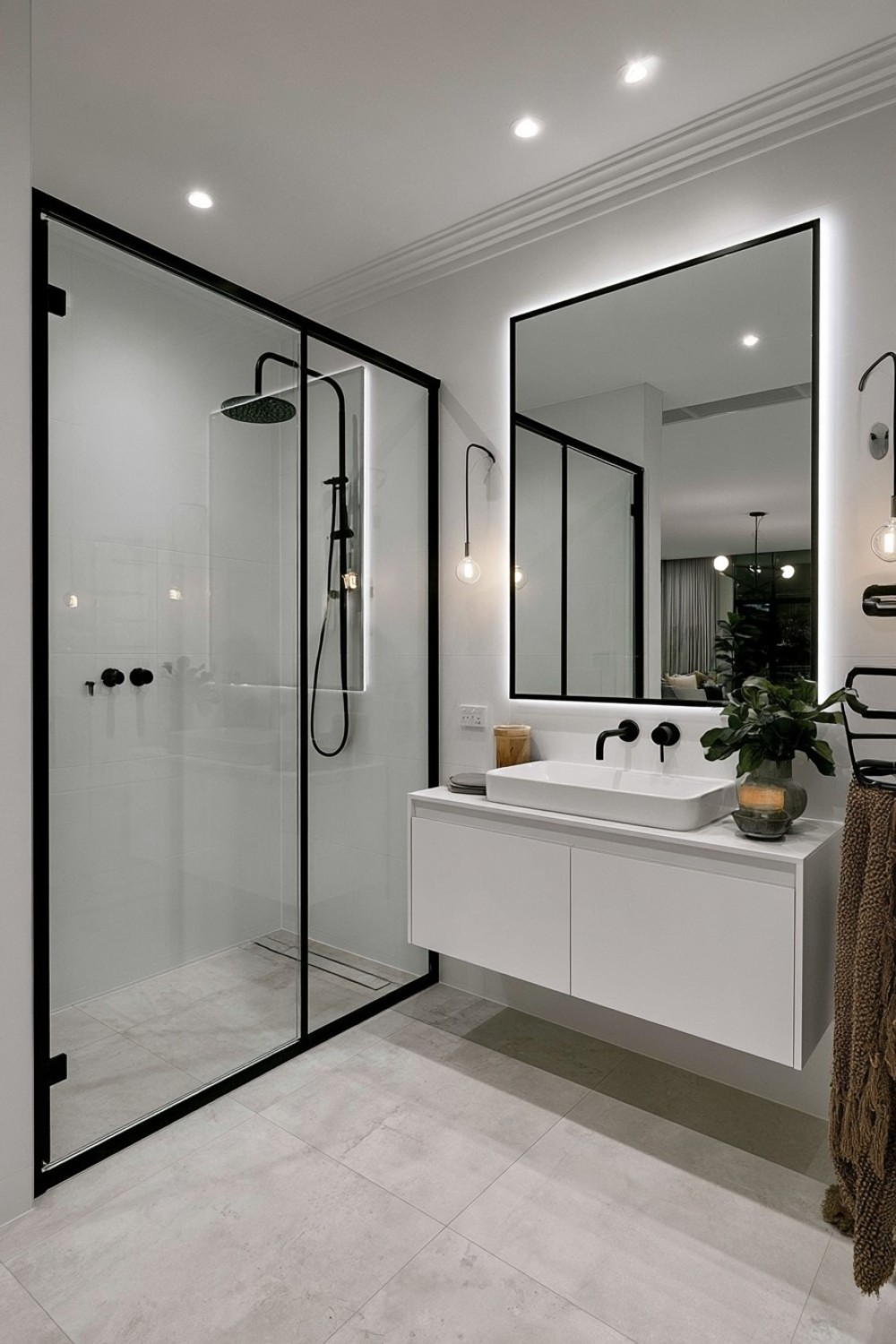 Bright white bathroom defined by thin black architectural details