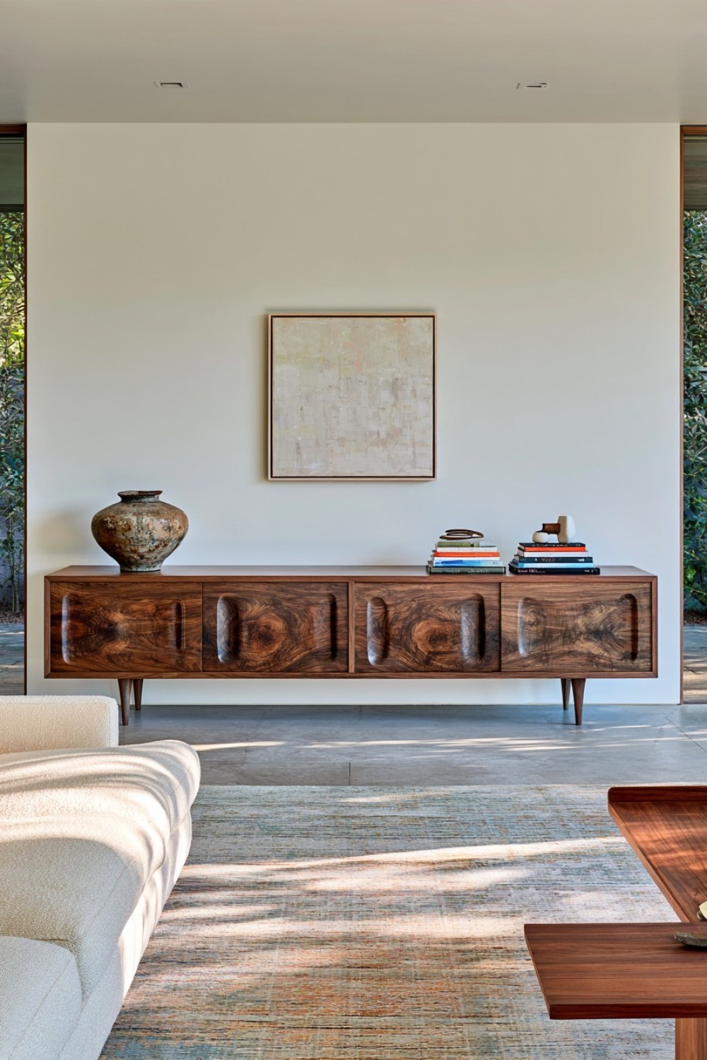Long walnut credenza styled as a mid-century display zone