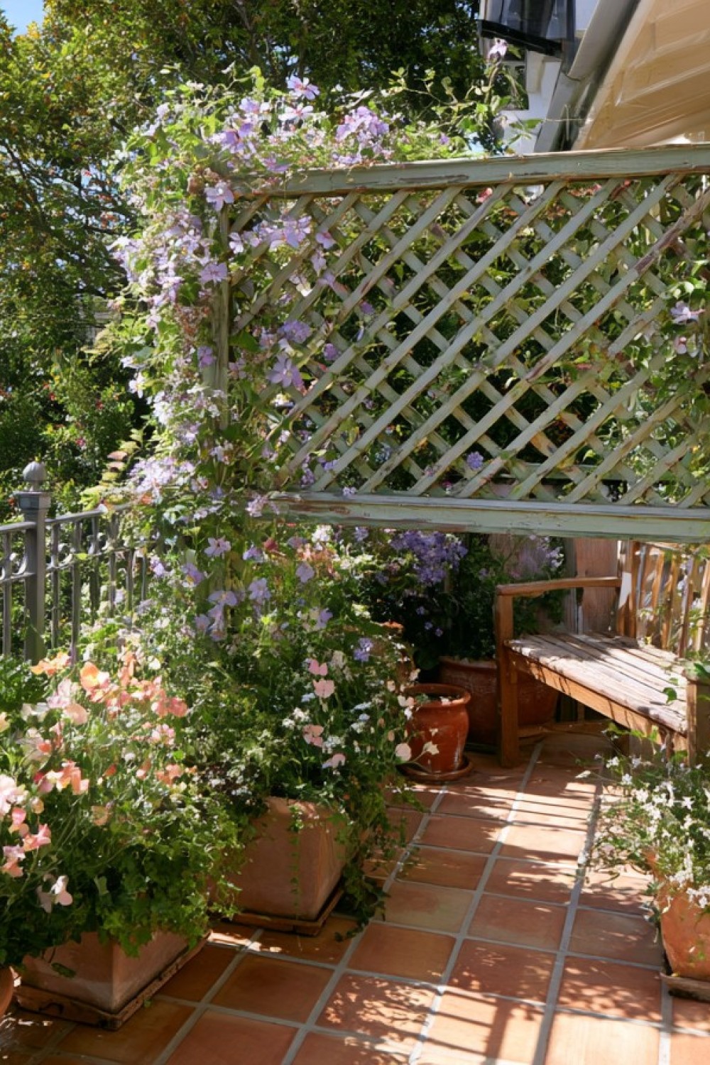 Partial decorative privacy screen secured inside a cottage balcony