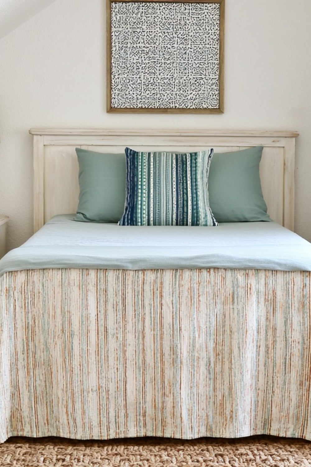 Airy coastal attic bedroom with pale blue and natural woven details