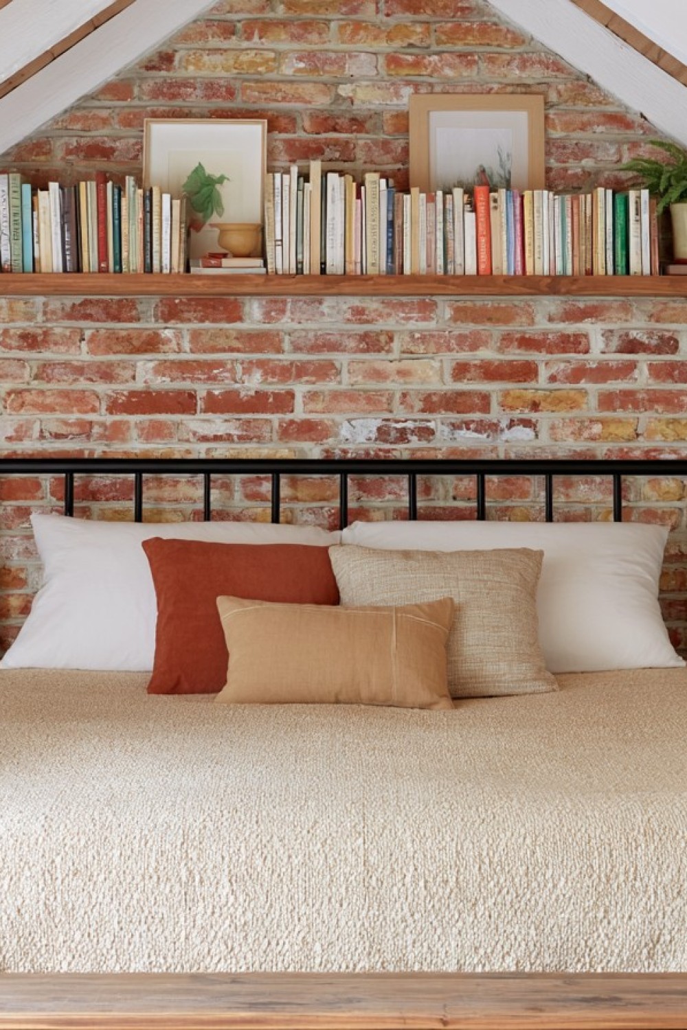 Industrial attic bedroom with metal furniture and exposed structural details