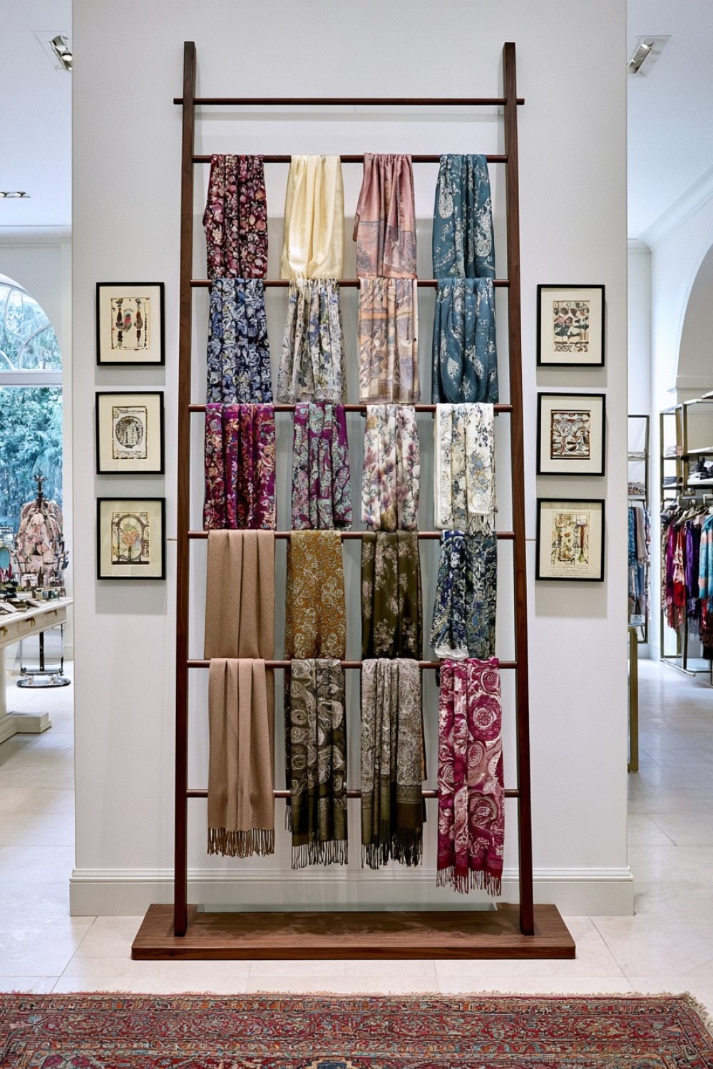 Freestanding ladder-style scarf display inside a boutique