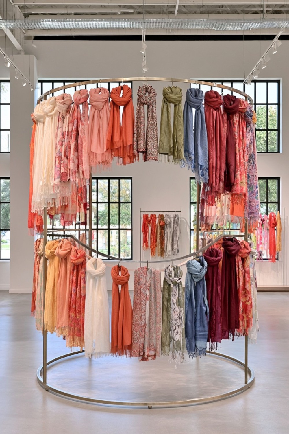 Circular scarf rack used as a central boutique display