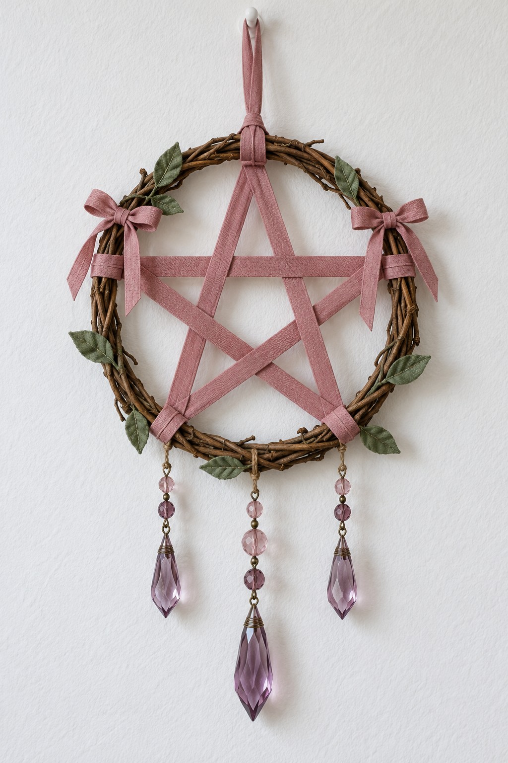 Grapevine ring with a dusty rose ribbon star, small leaves, side bows and three purple faceted pendants