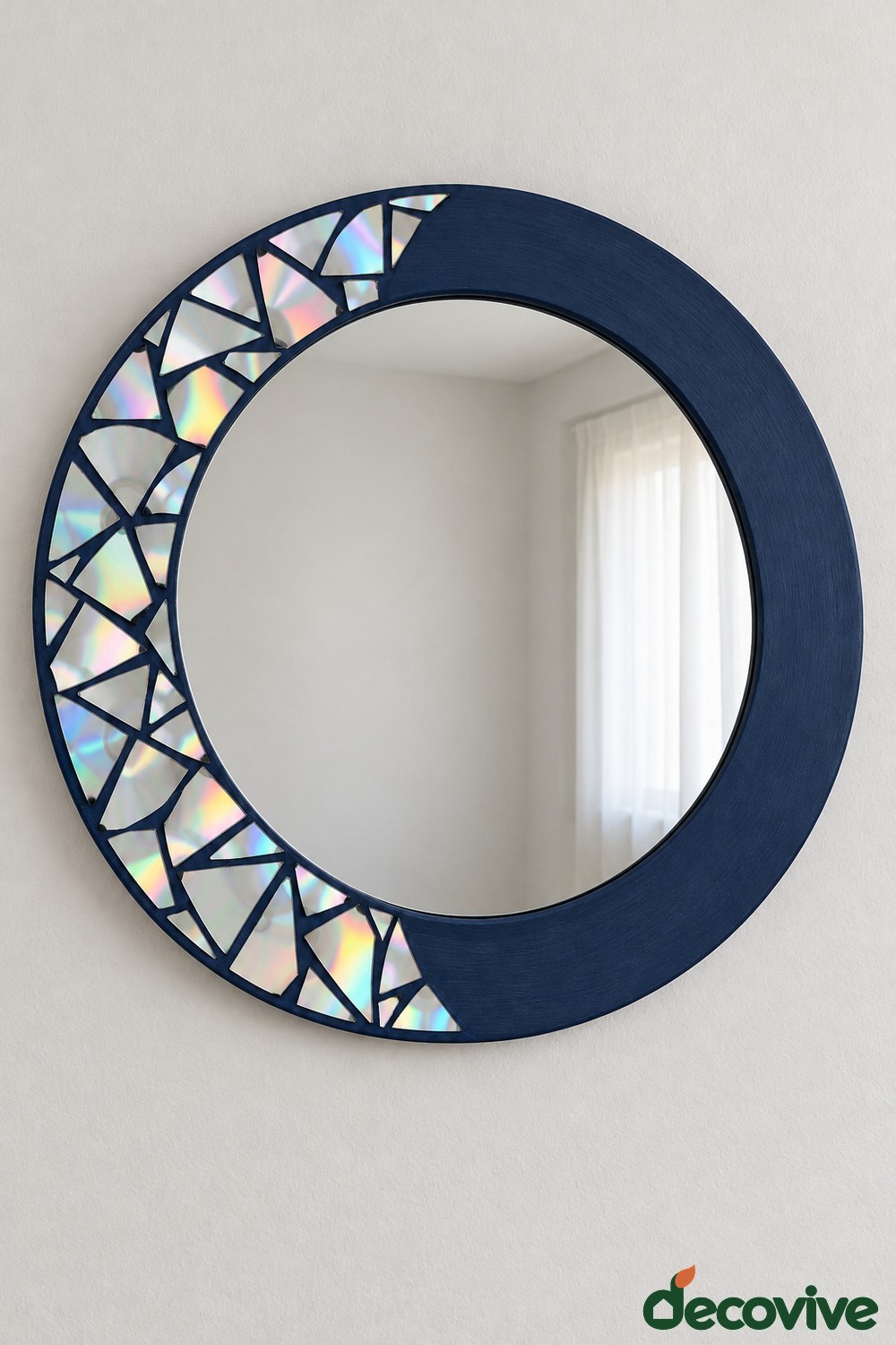 Round navy mirror frame with an iridescent mosaic crescent along the left side