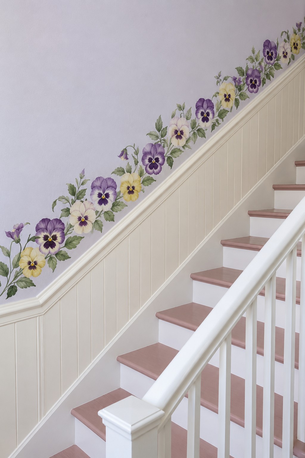 Purple and cream pansy border following a stair wall above cream paneling and pink treads