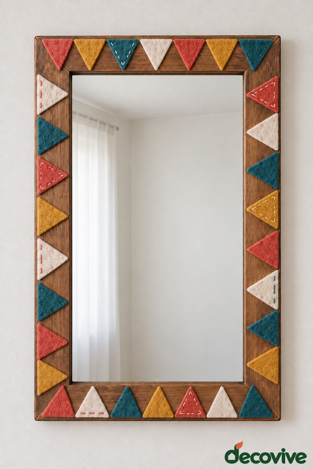Wooden rectangular mirror with red mustard teal and cream felt triangles and decorative stitching