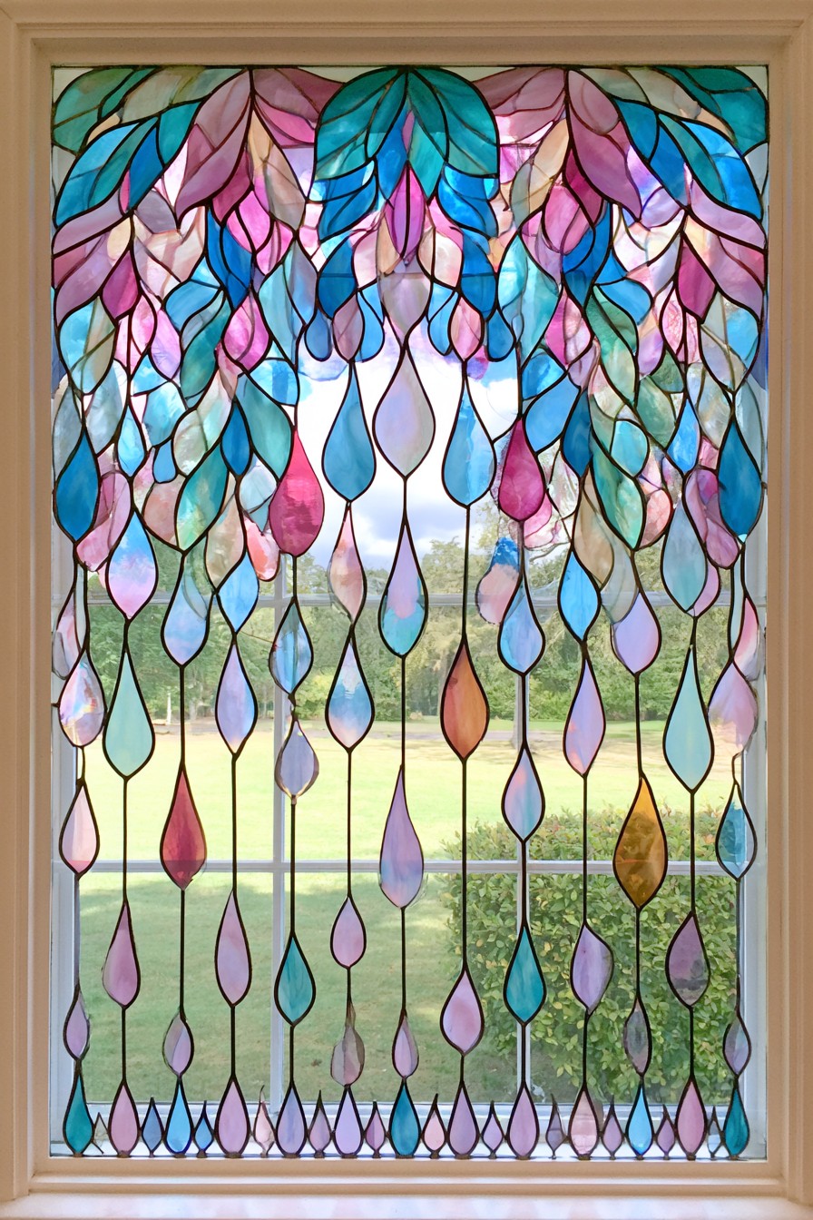 Dense blue, teal, pink, and lavender leaf shapes above widely spaced hanging teardrops