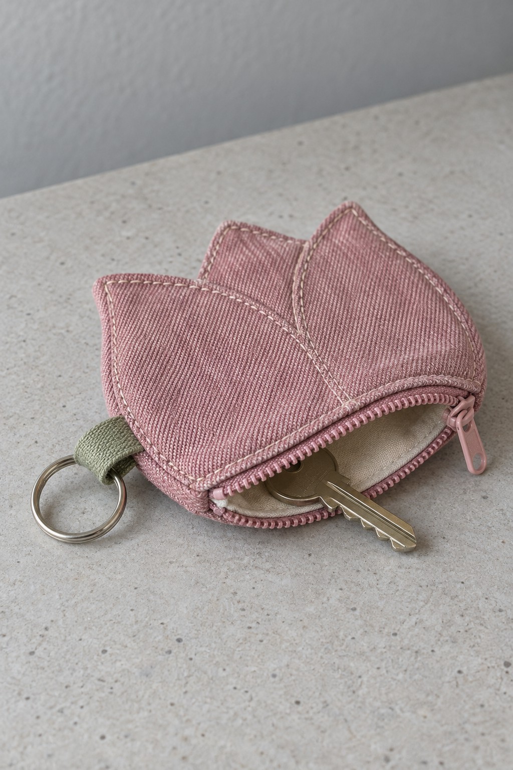 Pink tulip shaped zippered key pouch with cream lining and a sage ring tab
