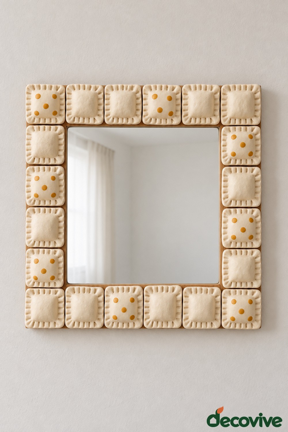 Rectangular mirror bordered by cream square clay tiles with fork pressed edges and mustard dots