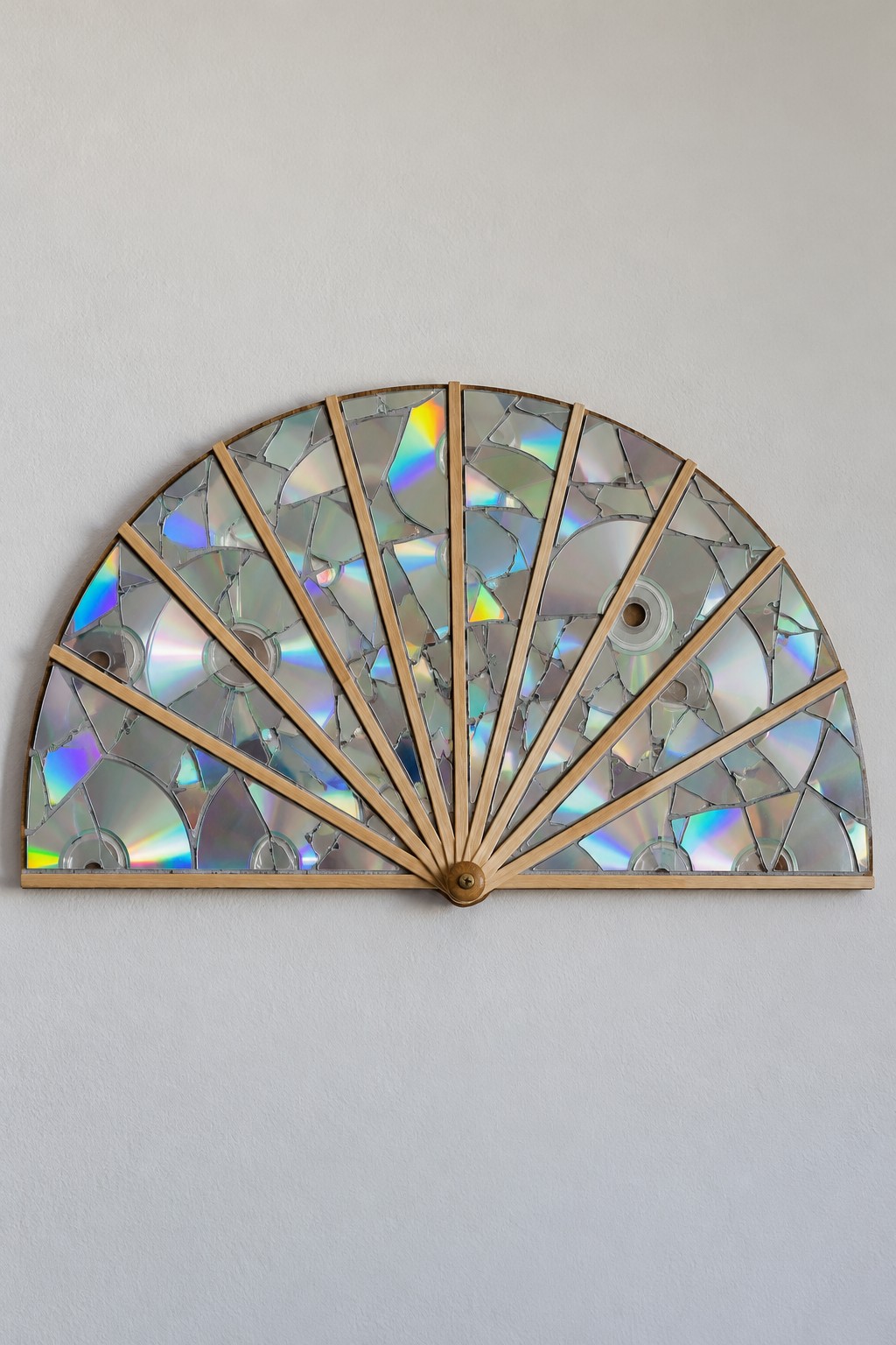 Semicircular wall fan with wooden radial ribs and an iridescent mosaic made from reclaimed discs