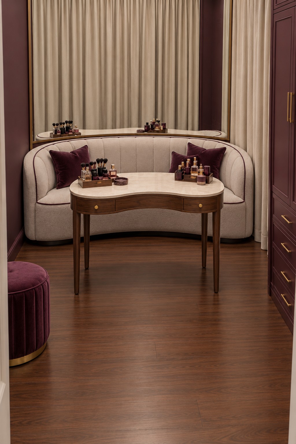 Cream curved sofa with plum cushions behind a curved wooden dressing table in a plum and cream room