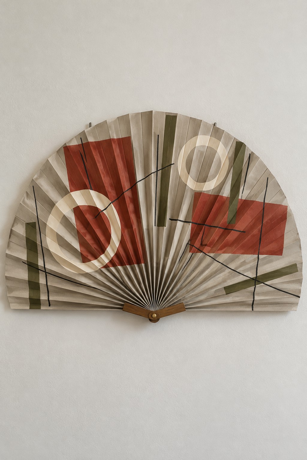 Large decorative folding fan with cream, brown and rust geometric patterns
