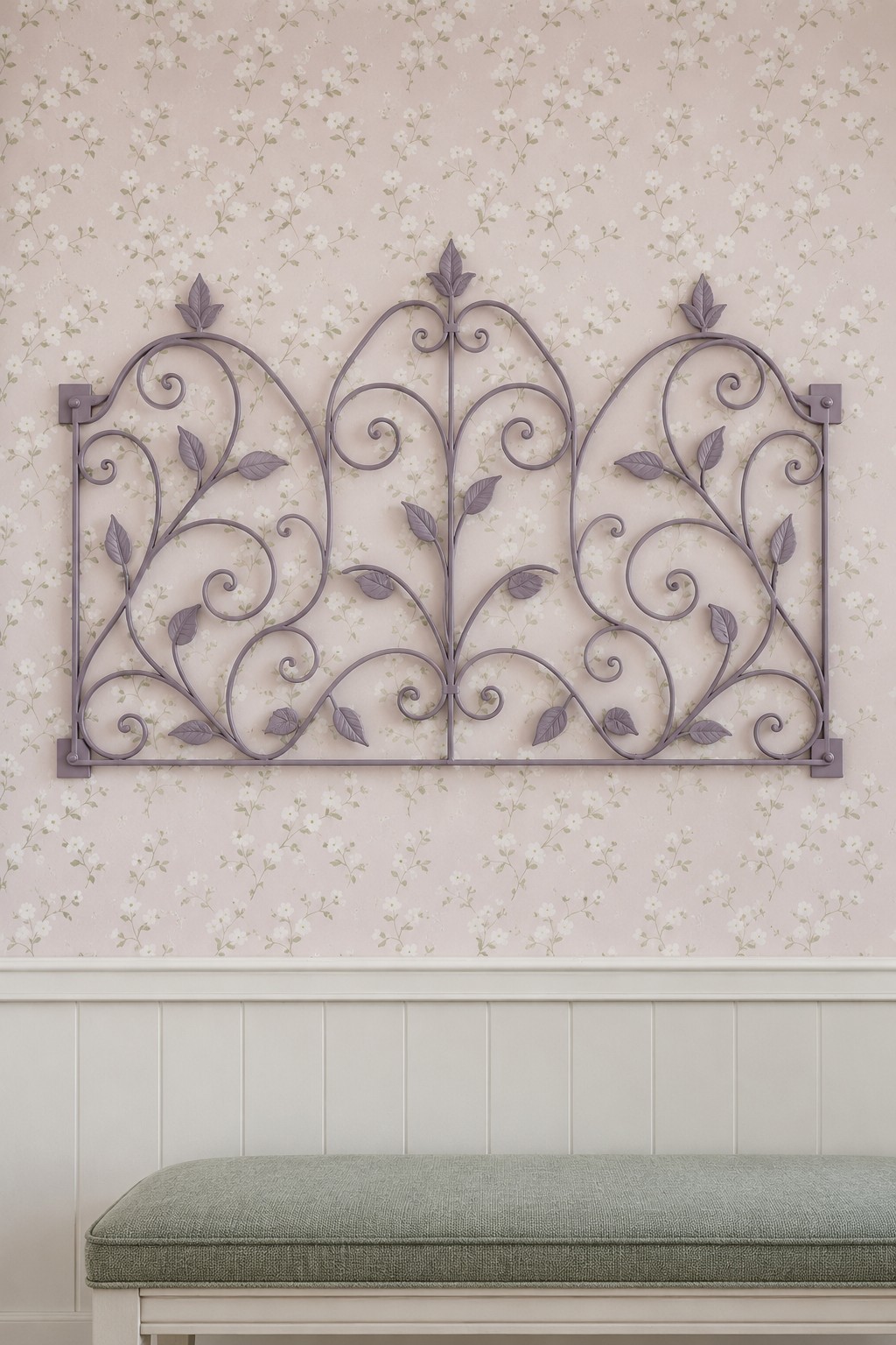 Lavender metal garden scrollwork with leaf details and visible corner mounting plates above a green bench