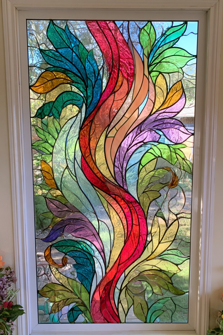 Curving red and coral ribbons surrounded by teal, green, purple, and gold leaflike shapes