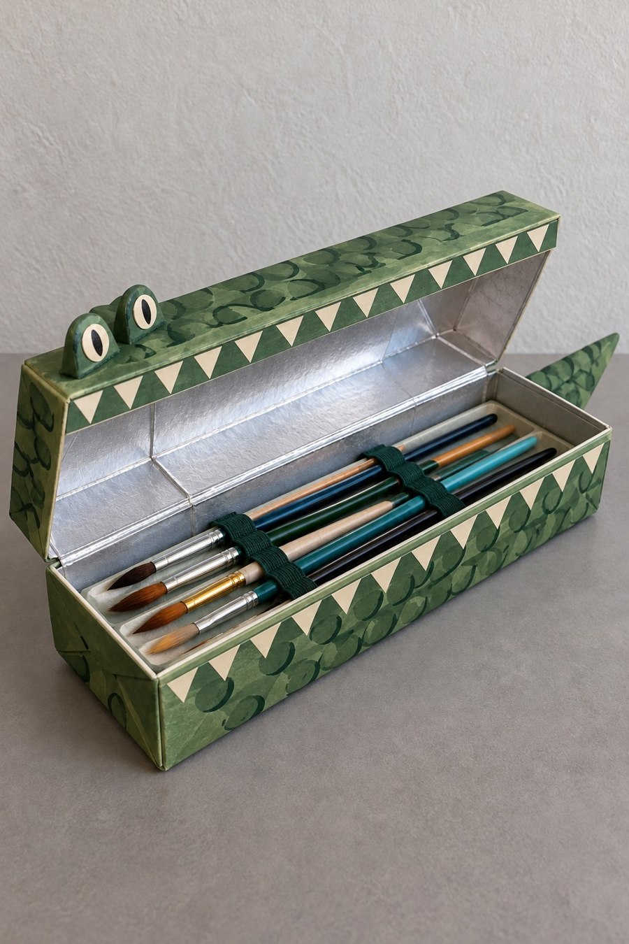 Green crocodile pencil box with triangular teeth and a long open lid