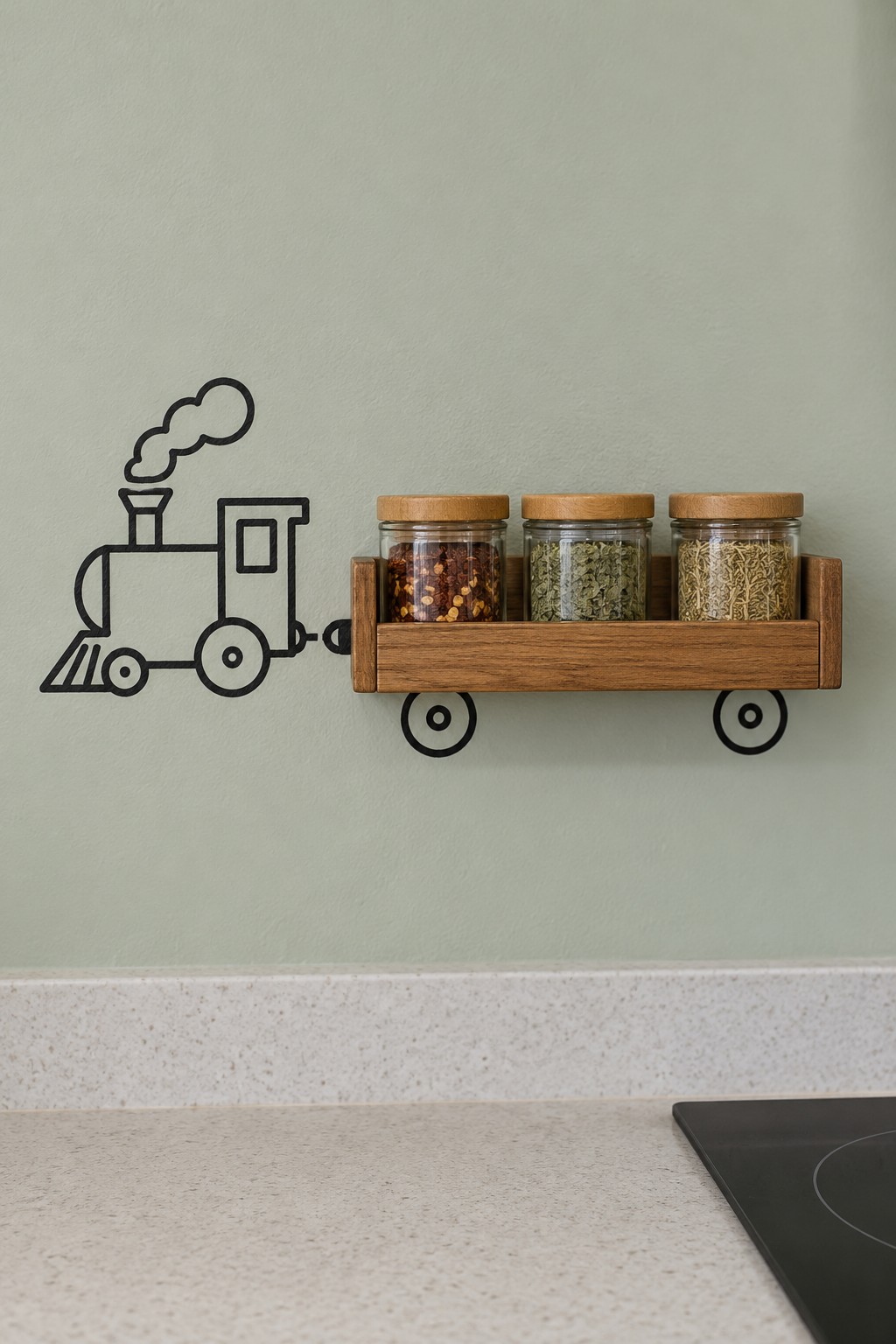 Wooden spice rack with three jars forming a train wagon beside a painted locomotive on a pale green wall
