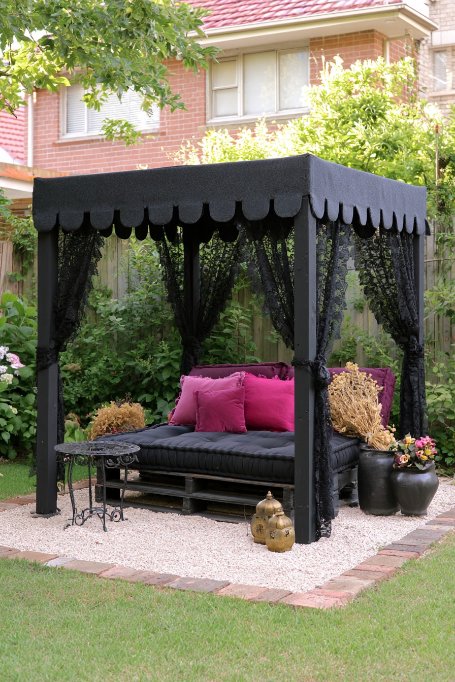 Black scalloped canopy with lace curtains, a pallet-style daybed, and magenta cushions