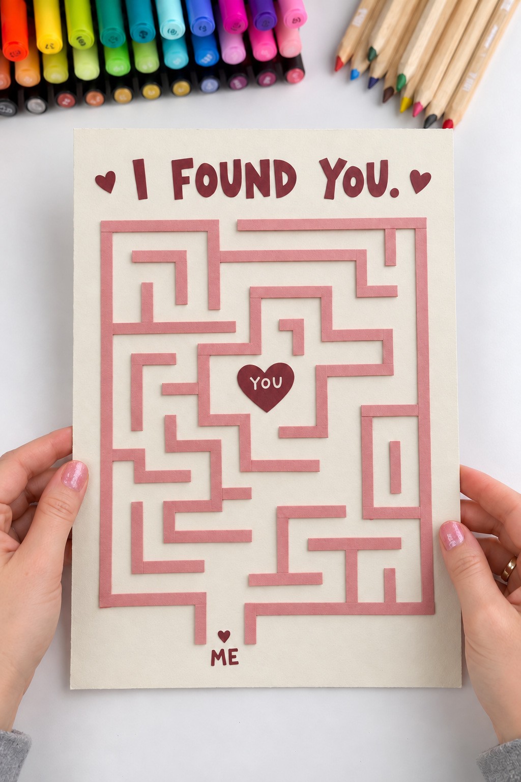 Unsolved pink cardstock maze on an ivory I Found You poster with a central You heart and bottom Me entrance