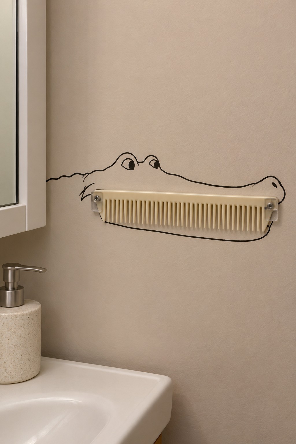 Cream comb held horizontally inside a painted crocodile mouth beside a bathroom mirror
