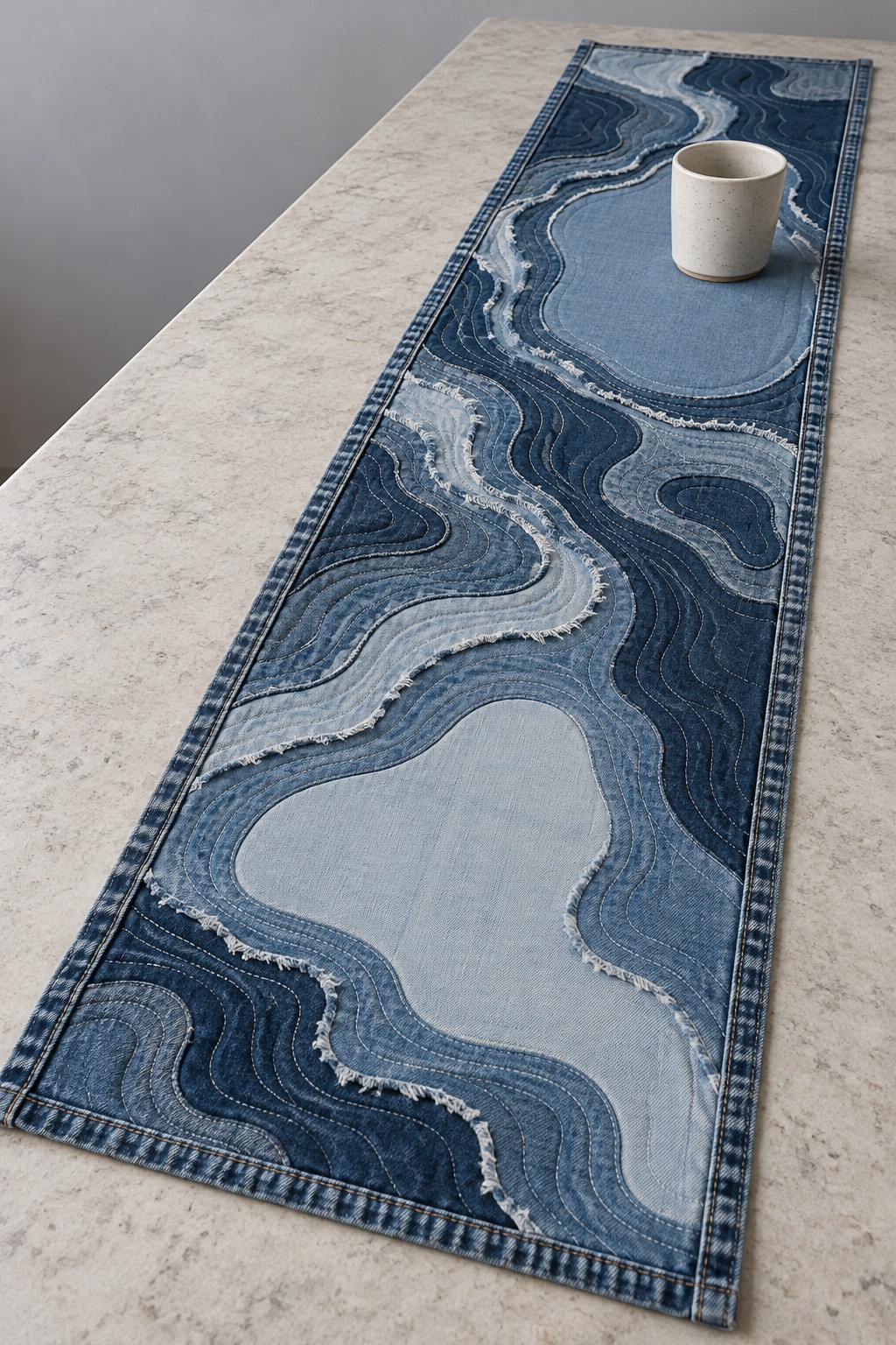 Long denim table runner with flowing pale blue and dark blue patchwork shapes