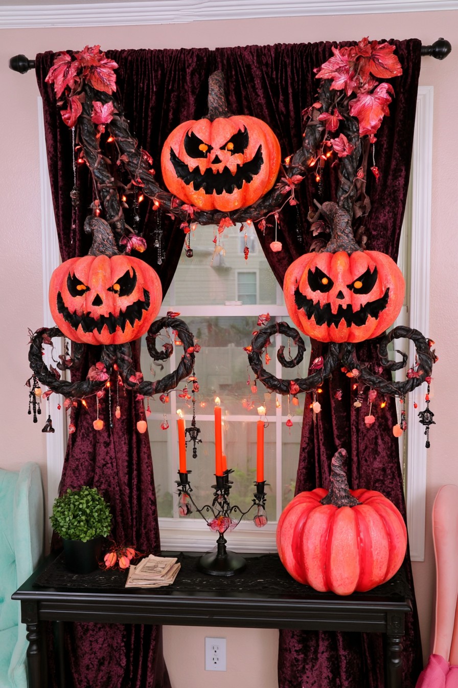 Three orange pumpkin faces and dark vines framing burgundy curtains