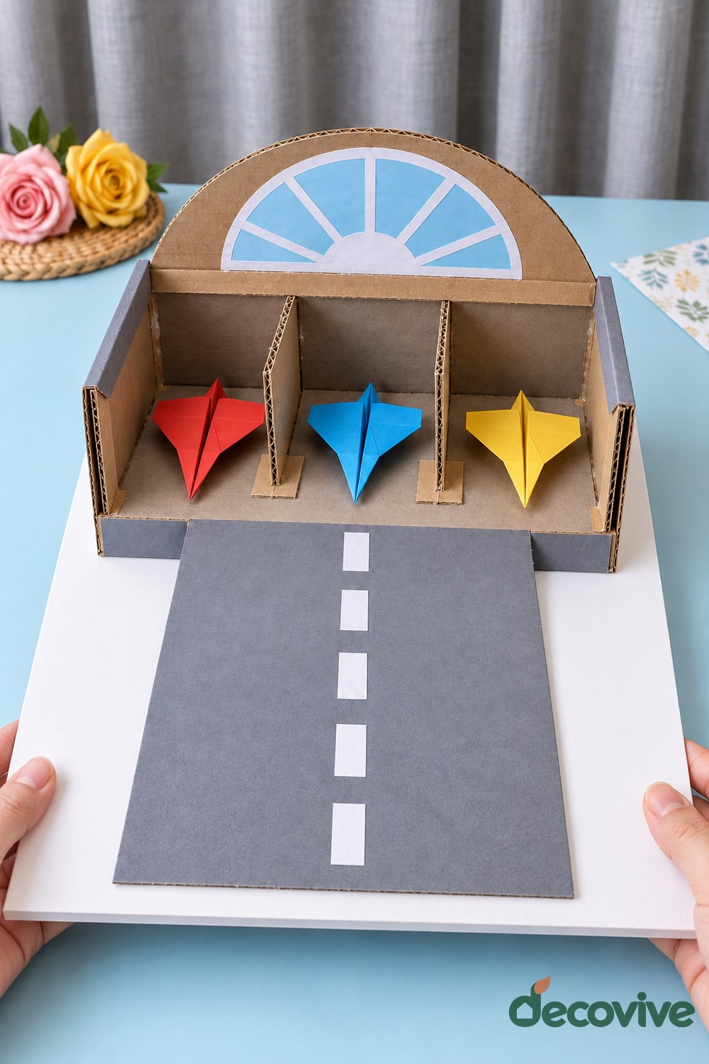 Finished cardboard airplane hangar and paper runway