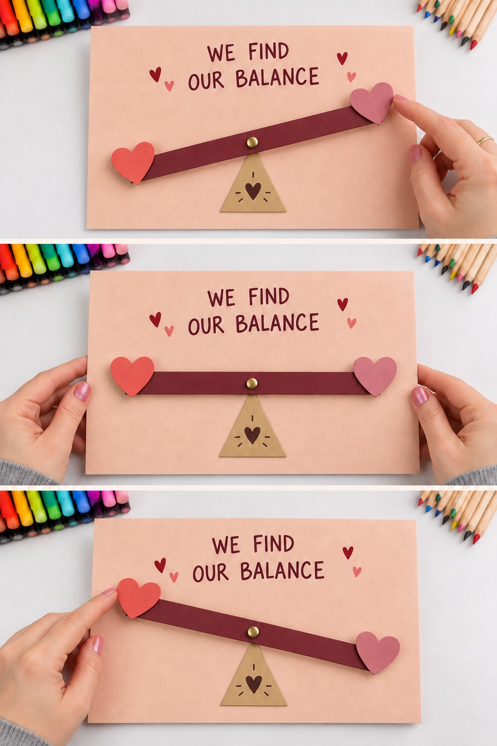 Three positions of a burgundy paper seesaw with heart ends pivoting above a triangle under We Find Our Balance
