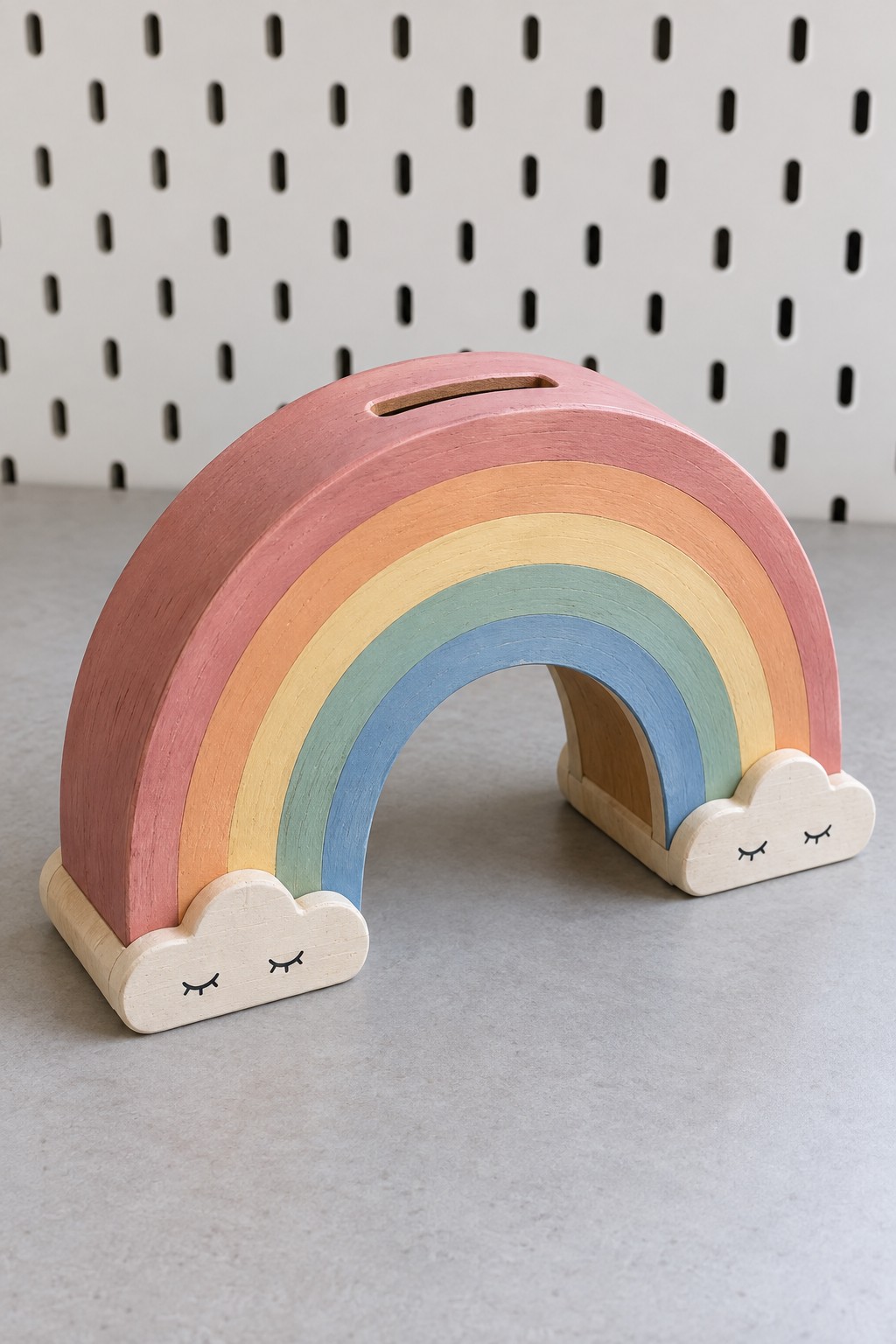 Pastel wooden rainbow coin bank with a top slot, open arch and two cream cloud feet