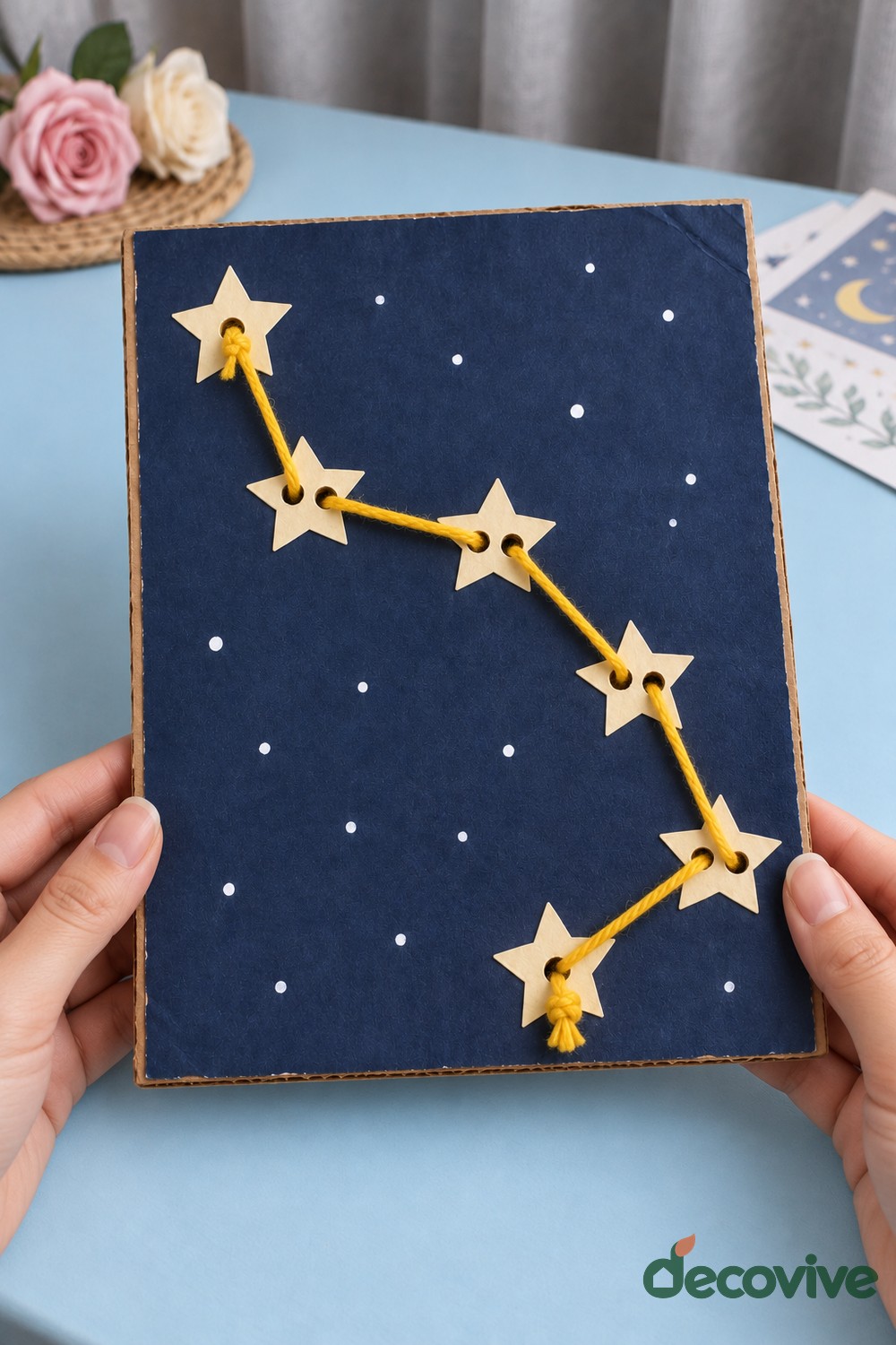 Finished yarn constellation picture with paper stars