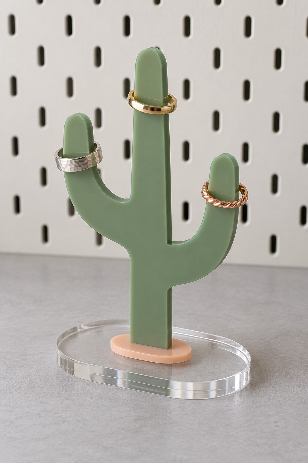 Sage acrylic cactus ring stand on a pink mount and clear oval base