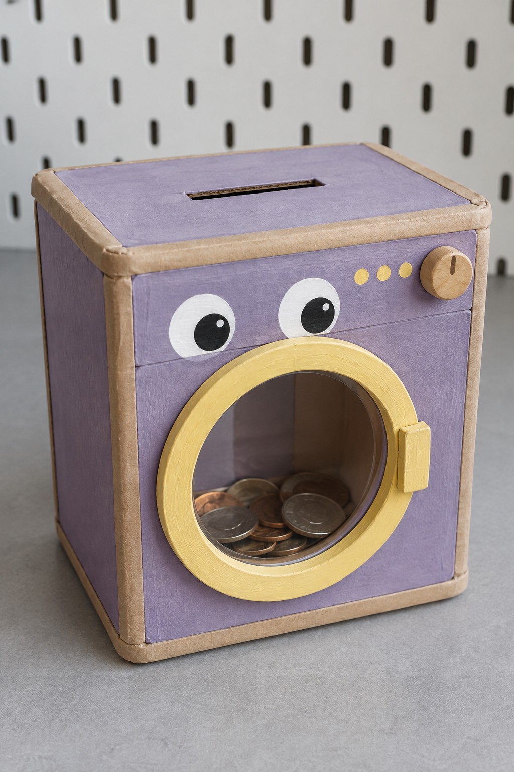 Lavender washing machine coin bank with yellow circular window trim and decorative controls