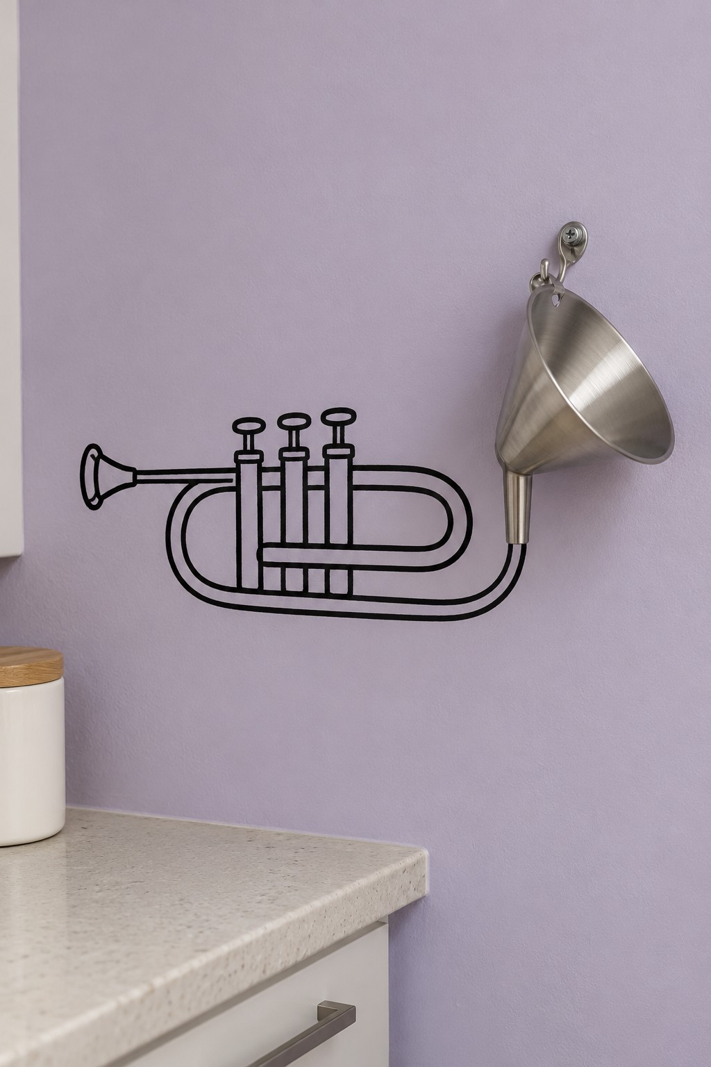 Stainless steel funnel forming the bell of a black trumpet outline on a lavender kitchen wall
