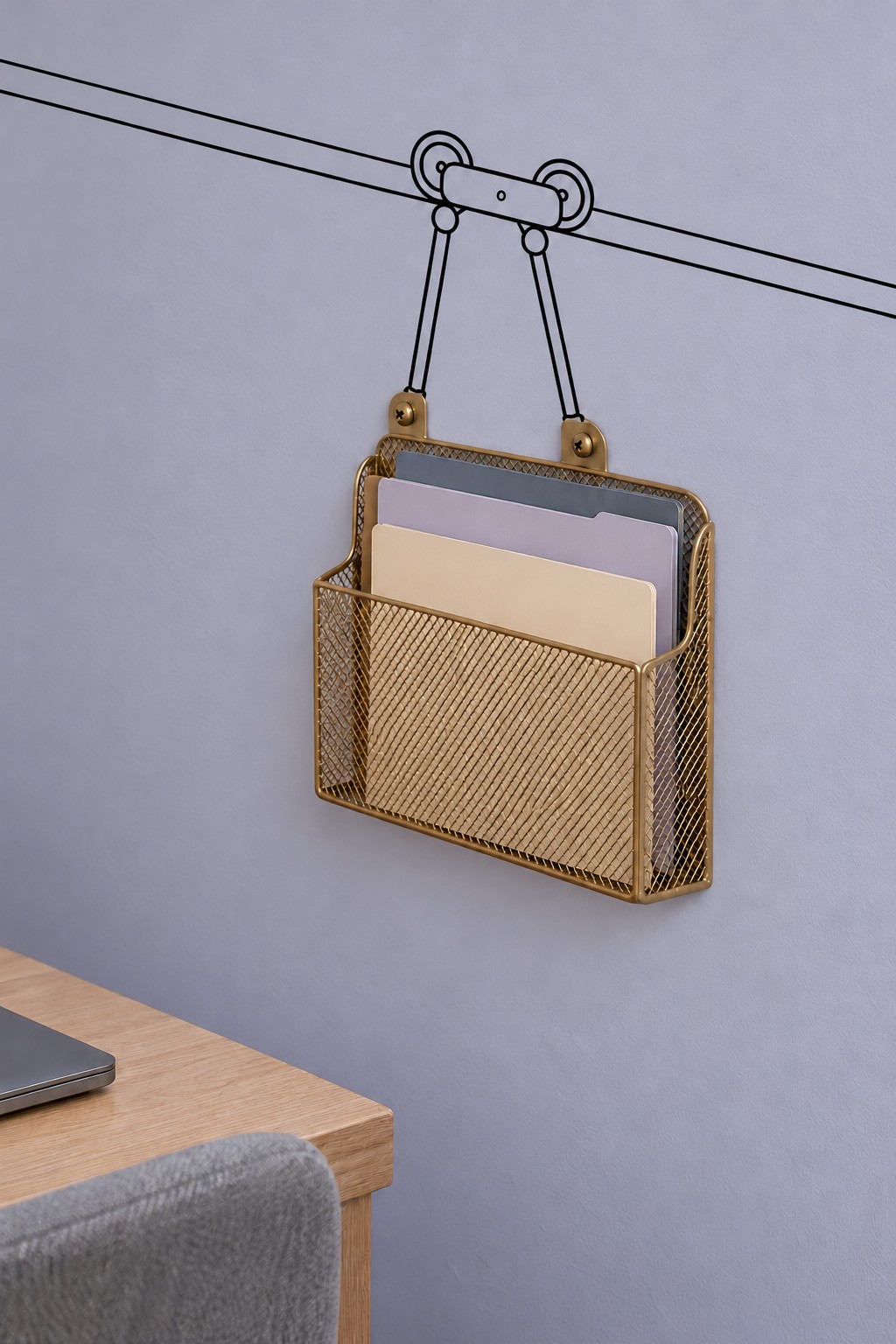 Gold wire wall file basket beneath a drawn cable car suspension on a lavender office wall