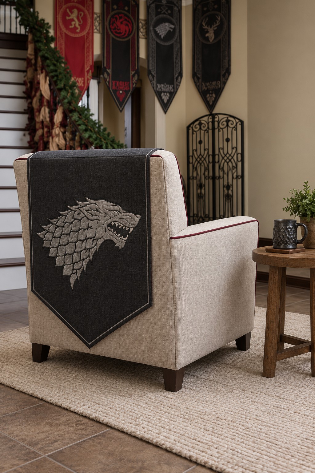 Cream armchair with burgundy piping and a charcoal runner bearing a silver direwolf motif over the back