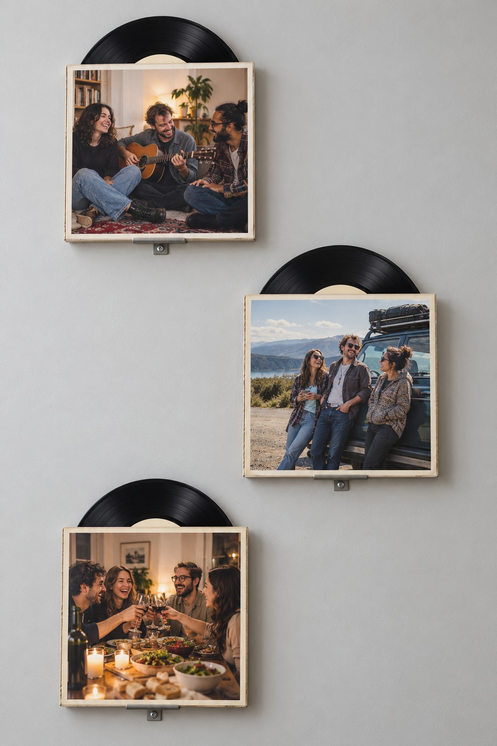Three staggered square photo sleeves with black vinyl record arcs visible above them