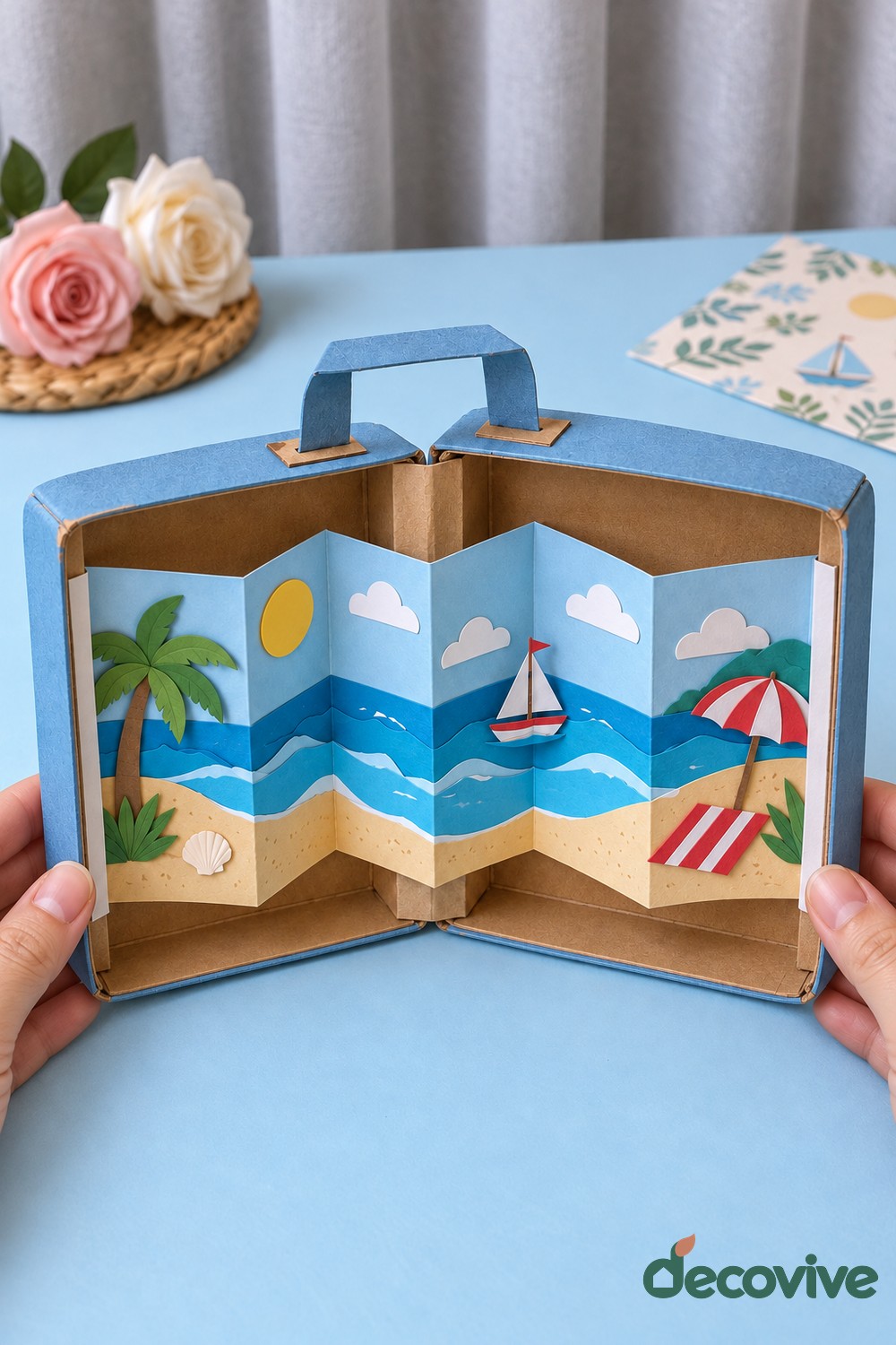 Finished cardboard suitcase with an accordion beach scene