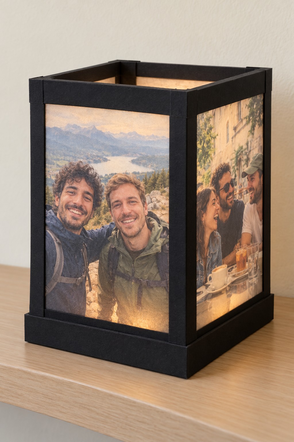 Black rectangular lantern with illuminated translucent travel photographs in its side panels