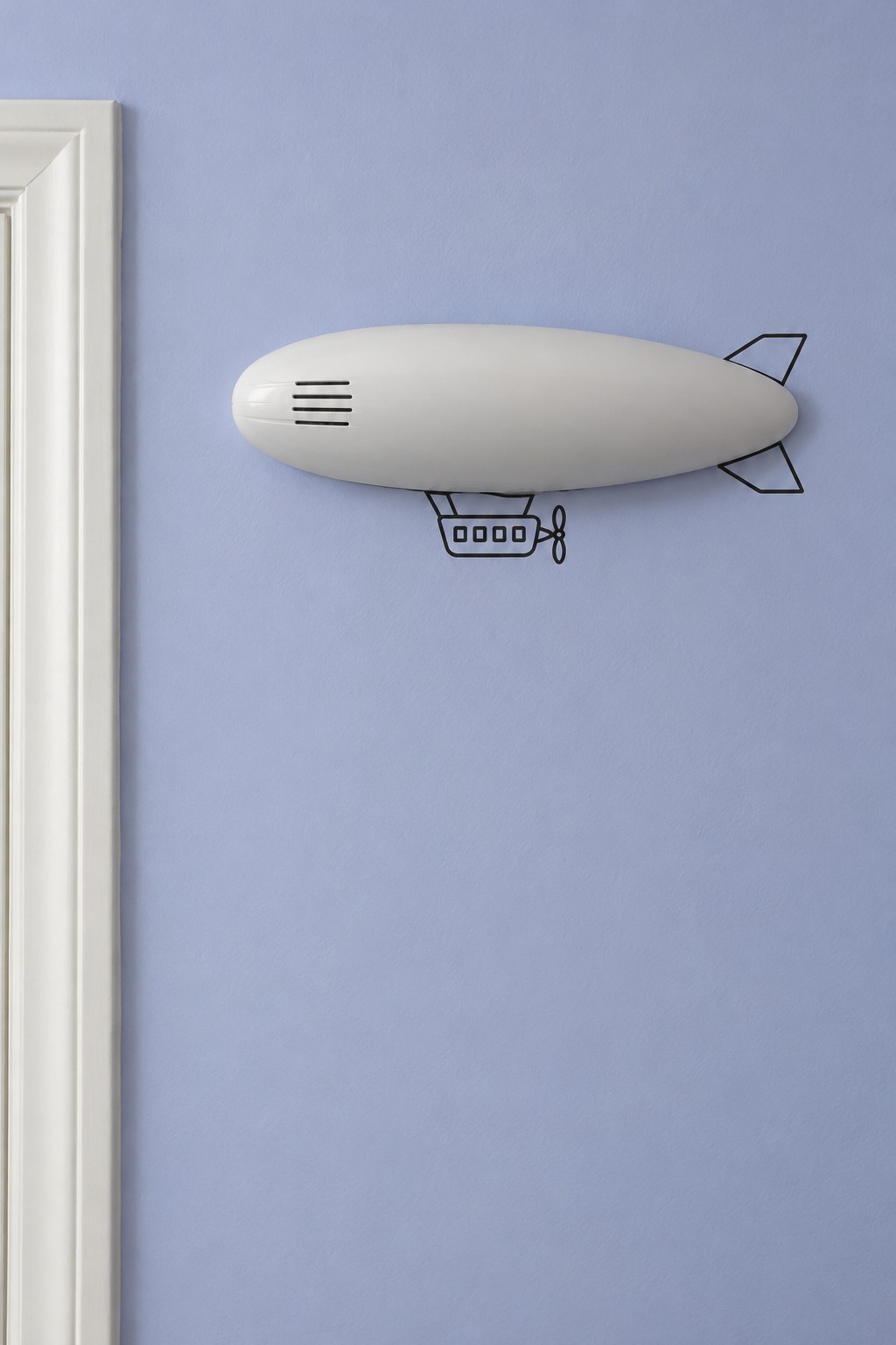 Elongated white wall fixture completed with painted airship fins and a small gondola on a lavender blue wall