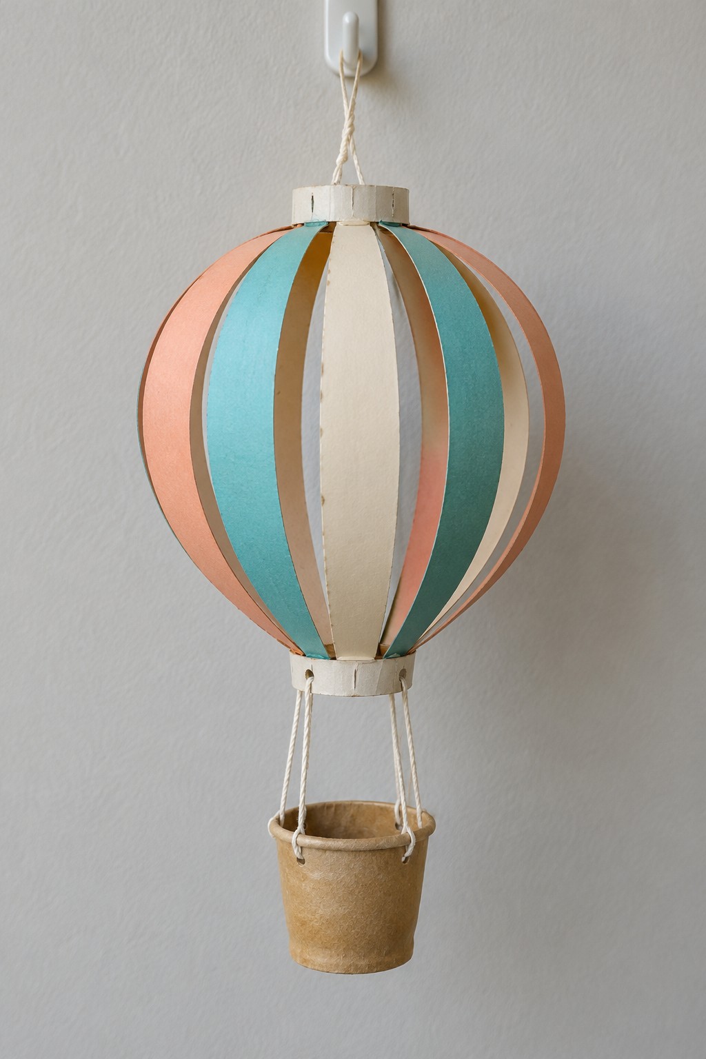 Pastel peach blue and cream strip balloon with a small brown paper cup basket hanging below