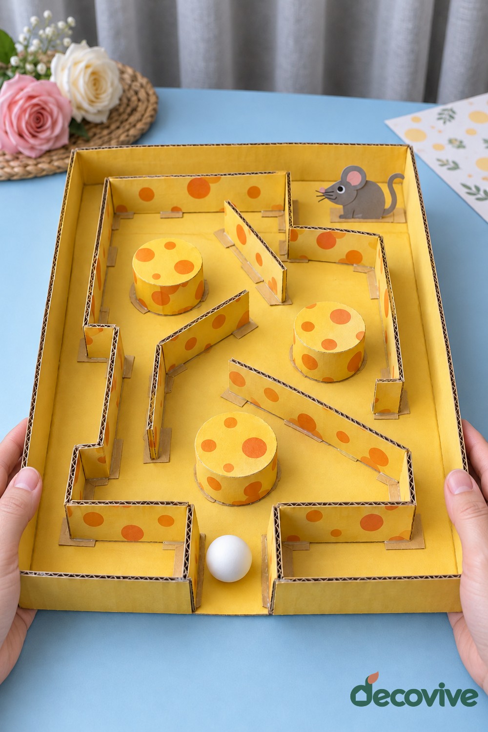 Finished cardboard cheese maze with a rolling ball